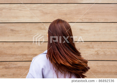 Young woman waves her hair. Back view. 86892536