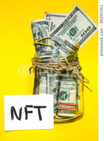 NFT non-fungible token text. Concept words NFT non-fungible token on paper blank. Background of dollar bills. Blockchain asset crypto art, digital art, new type of cryptorurrency Money against future NFT non-fungible token text. Concept words NFT non-fungible token on paper blank. Background of dollar bills. Blockchain asset crypto art, digital art, new type of cryptorurrency Money against future 86892561