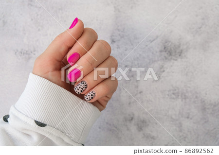 Manicured female hands with stylish pink nails and design. Trendy modern design manicure. Gel nails. Skin care. Beauty treatment. Nail care. Trendy colors Manicured female hands with stylish pink nails and design. Trendy modern design manicure. Gel nails. Skin care. Beauty treatment. Nail care. Trendy colors 86892562