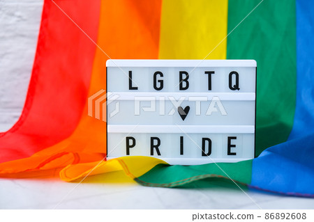 Rainbow flag with lightbox and text LGBTQ PRIDE. Rainbow lgbtq flag made from silk material. Symbol of LGBTQ pride month. Equal rights. Peace and freedom Rainbow flag with lightbox and text LGBTQ PRIDE. Rainbow lgbtq flag made from silk material. Symbol of LGBTQ pride month. Equal rights. Peace and freedom 86892608
