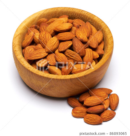 Wooden bowl full of Almond nuts isolated on a white background 86893065