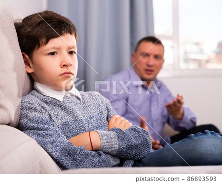 Troubled boy scolded by father Troubled boy scolded by father 86893593