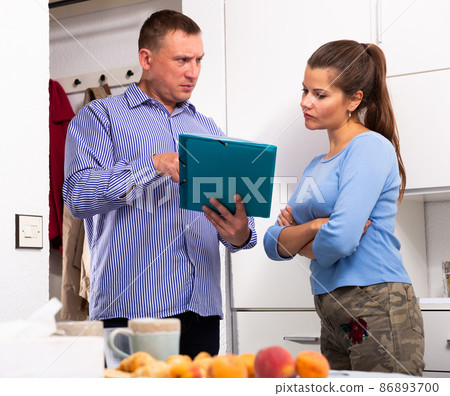 Businessman trying to collect arrearages from woman at home door Businessman trying to collect arrearages from woman at home door 86893700
