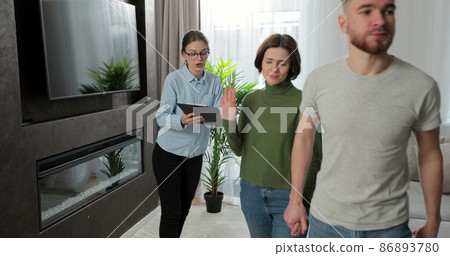 Angry couple with real estate agent visiting apartment for rent or sale. Buying home concept. 86893780