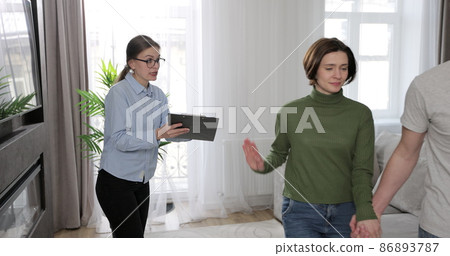 Real estate broker dealing with disturbed clients about buying new house or for rent. Buying home concept. Real estate broker dealing with disturbed clients about buying new house or for rent. Buying home concept. 86893787
