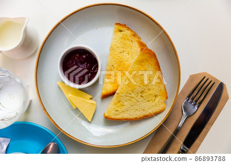 Breakfast. Croutons with cheese and jam on table Breakfast. Croutons with cheese and jam on table 86893788