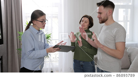 Real estate broker dealing with disturbed clients about buying new house or for rent. Buying home concept. Real estate broker dealing with disturbed clients about buying new house or for rent. Buying home concept. 86893789