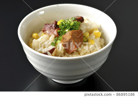 Photographed rice cooked with yakitori and corn on a black background 86895186