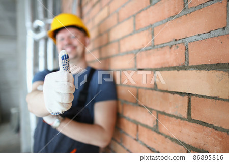 Foreman in helmet show thumbs up on construction site, handyman made good job Foreman in helmet show thumbs up on construction site, handyman made good job 86895816