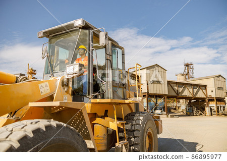 Manual worker driving cargo truck in plant 86895977