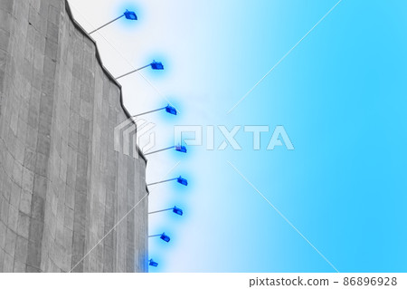 Concrete old building architecture structure cement facade apartment stone with elements of illumination bulbs on the roof against a background of sky 86896928