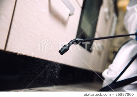 Spray gun with pesticides close-up. Fight against insects in apartments and houses. Disinsection of premises Spray gun with pesticides close-up. Fight against insects in apartments and houses. Disinsection of premises 86897800