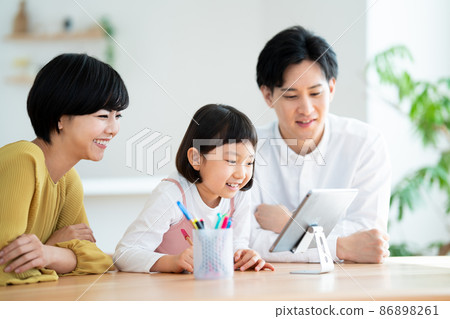 A child studying while looking at a tablet A child studying while looking at a tablet 86898261