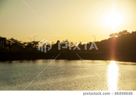 Pond where the setting sun is reflected Pond where the setting sun is reflected 86898686