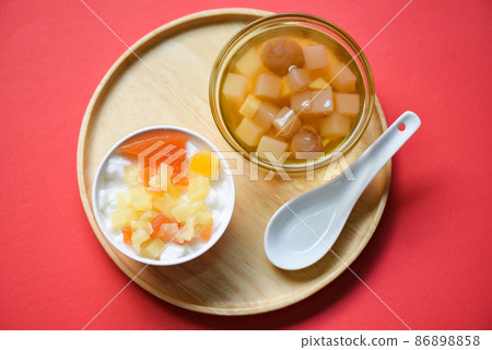 Chinese desserts, milk pudding fruit salad and Mix ginkgo nuts cassava syrup coconut jelly in longan juice on glass bowl, Thai and Chinese longan date soup Asian dessert sweets Chinese desserts, milk pudding fruit salad and Mix ginkgo nuts cassava syrup coconut jelly in longan juice on glass bowl, Thai and Chinese longan date soup Asian dessert sweets 86898858
