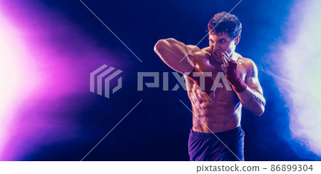 Muay thai fighter training an elbow hit isolated on smoke background. Sport concept. mixed media  86899304