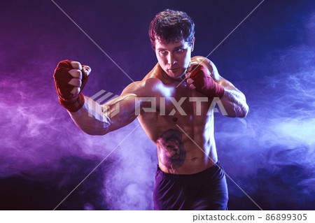 Half length of athlete shirtless boxer who preparing for fight on smoke background. Sport concept 86899305