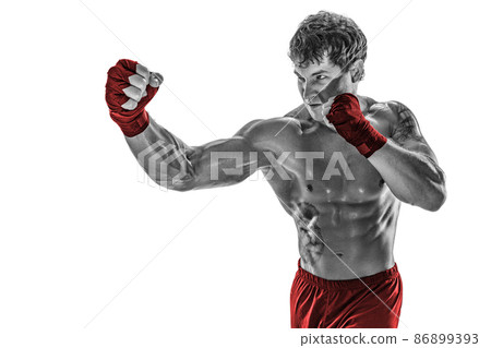 Portrait of boxer who practicing right hook on white background. Black and white. Red sportswear Portrait of boxer who practicing right hook on white background. Black and white. Red sportswear 86899393