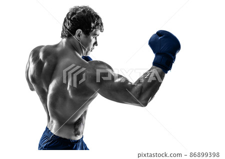 Side view of boxer in blue gloves who practicing uppercut on white background. Black and white 86899398