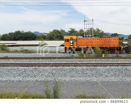 The old locomotive used to transport concrete sleepers to lay railroad tracks. 86899623