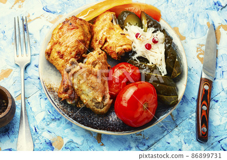 Baked chicken and pickles. 86899731