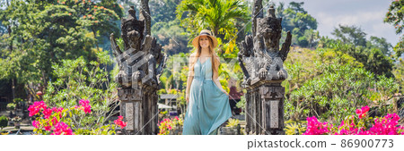 Young woman tourist in Taman Tirtagangga, Water palace, Water park, Bali Indonesia BANNER, LONG FORMAT 86900773