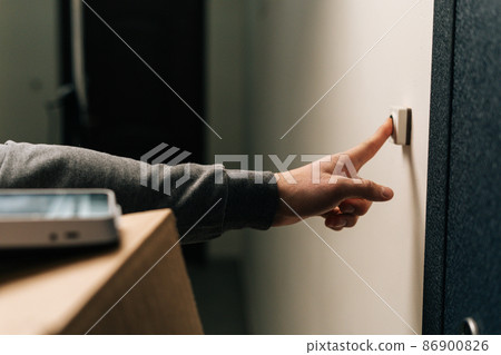 Close-up hands of unrecognizable delivery man ringing doorbell of customer apartment holding cardboard box, contactless payment POS wireless terminal for card paying. Concept of online shopping. Close-up hands of unrecognizable delivery man ringing doorbell of customer apartment holding cardboard box, contactless payment POS wireless terminal for card paying. Concept of online shopping. 86900826