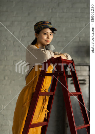 A woman riding a ladder with an apron 86901280