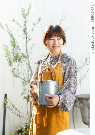 A woman enjoying gardening 86901473