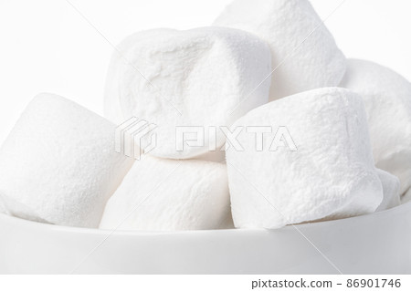 Background of marshmallow pieces on white close up Background of marshmallow pieces on white close up 86901746