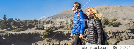 BANNER, LONG FORMAT Young couple man and woman visit the Bromo volcano at the Tengger Semeru National Park on the Java Island, Indonesia. They enjoy magnificent view on the Bromo or Gunung Bromo on BANNER, LONG FORMAT Young couple man and woman visit the Bromo volcano at the Tengger Semeru National Park on the Java Island, Indonesia. They enjoy magnificent view on the Bromo or Gunung Bromo on 86901795