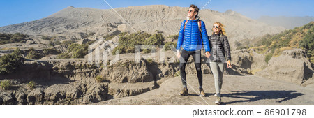 BANNER, LONG FORMAT Young couple man and woman visit the Bromo volcano at the Tengger Semeru National Park on the Java Island, Indonesia. They enjoy magnificent view on the Bromo or Gunung Bromo on 86901798