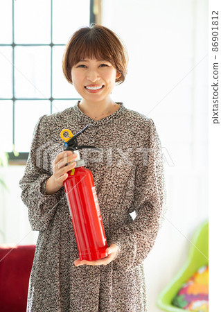 Woman with fire extinguisher Woman with fire extinguisher 86901812