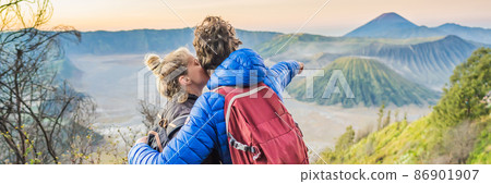 BANNER, LONG FORMAT Young couple man and woman meet the sunrise at the Bromo Tengger Semeru National Park on the Java Island, Indonesia. They enjoy magnificent view on the Bromo or Gunung Bromo on BANNER, LONG FORMAT Young couple man and woman meet the sunrise at the Bromo Tengger Semeru National Park on the Java Island, Indonesia. They enjoy magnificent view on the Bromo or Gunung Bromo on 86901907
