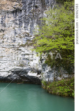 Blue lake, mountain Akhtsykh, Abkhazia, small lake with turquoise water in the mountains, spring, April Blue lake, mountain Akhtsykh, Abkhazia, small lake with turquoise water in the mountains, spring, April 86902363
