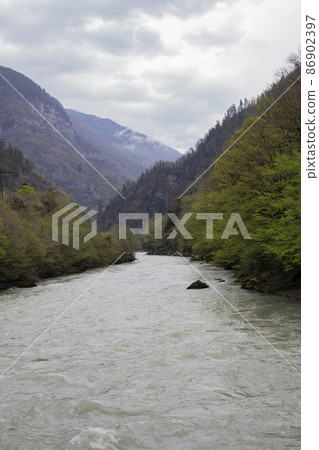 Blue river Bzyb in winter in April, Abkhazia Blue river Bzyb in winter in April, Abkhazia 86902397