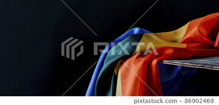 rainbow flag on a rustic table, web banner rainbow flag on a rustic table, web banner 86902469