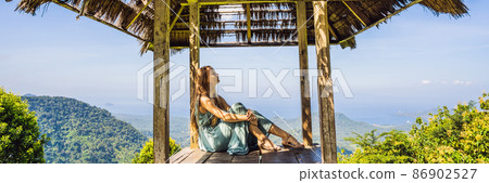 Young woman in traditional balinese gazebo. Bali island BANNER, LONG FORMAT 86902527