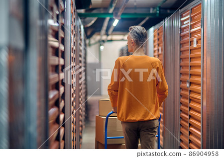 Loader wheeling the platform trolley along shipping containers Loader wheeling the platform trolley along shipping containers 86904958