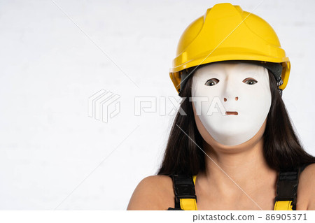 Close up anonymous face of a construction worker. Yellow protective helmet on the head. Occupational Health and Safety. 86905371