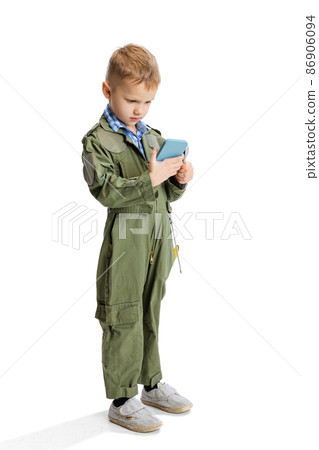 Portrait of little boy, cute kid in image of auto mechanic or fitter in green dungarees with work tools isolated over white studio background. Childhood, education concept Portrait of little boy, cute kid in image of auto mechanic or fitter in green dungarees with work tools isolated over white studio background. Childhood, education concept 86906094