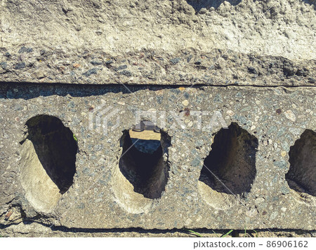construction site. There are many pieces of concrete on the site. gray concrete structure with holes. defective construction, unsuitable material 86906162