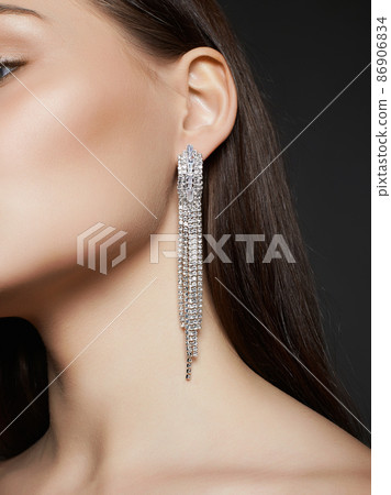 Beautiful young woman with jewelry earrings Beautiful young woman with jewelry earrings 86906834