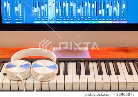 white headphone on midi keyboard. music production concept 86906875