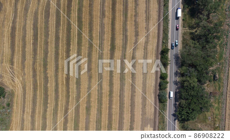 Wheat field in summer by the sea after harvest. Aerial view. 86908222