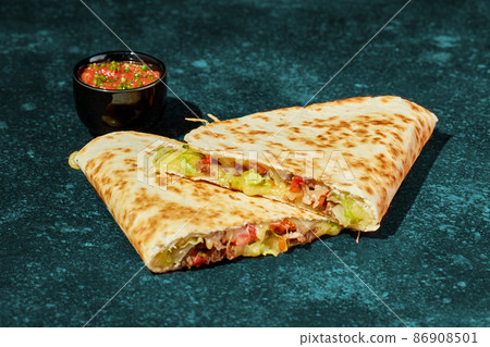 Quesadilla with chicken, cheese, vegetables and herbs and sauce Quesadilla with chicken, cheese, vegetables and herbs and sauce 86908501