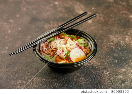 Birria ramen, consomme soup with beef and noodle. Mix of Mexican and Asian cuisine Birria ramen, consomme soup with beef and noodle. Mix of Mexican and Asian cuisine 86908503