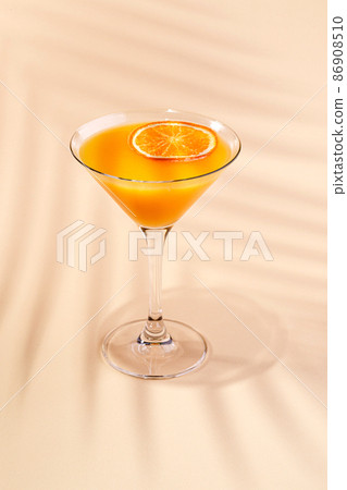 Cold alcoholic or non-alcoholic cocktail on pastel background. Hard light, deep shadow. Cold alcoholic or non-alcoholic cocktail on pastel background. Hard light, deep shadow. 86908510