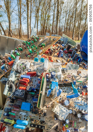 Waste polluting plastics and computer equipment dumped in a meadow. Waste polluting plastics and computer equipment dumped in a meadow. 86908766