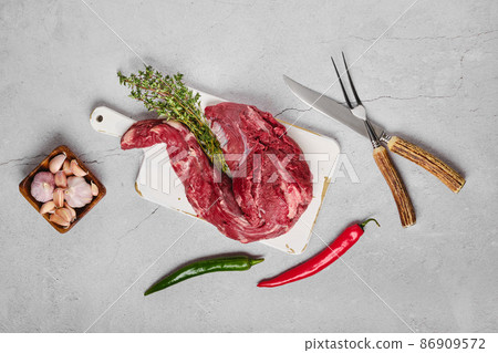 Raw beef whole tenderloin on concrete background 86909572